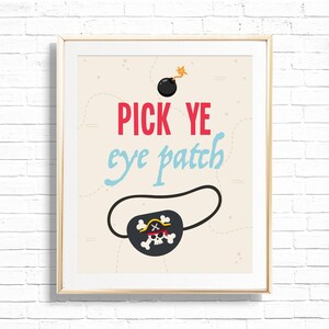 May include: Framed art print with a pirate theme. The artwork features the text "PICK YE eye patch" in red and light blue, along with a black eye patch with a skull and crossbones design. A black bomb with a lit fuse is at the top.