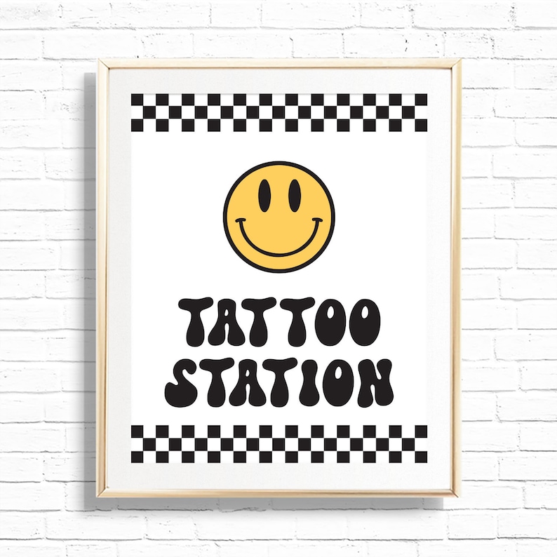 May include: A white sign with a black and white chequered border, a yellow smiley face, and the text "TATTOO STATION" in black, retro-style lettering.