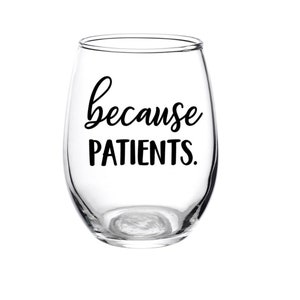 May include: A clear glass stemless wine glass with the text "because patients." printed in black.
