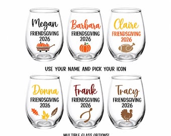 May include: Six clear stemless wine glasses featuring personalised names, the text "FRIENDSGIVING 2026," and various autumn-themed icons including a pumpkin cart, a pumpkin, a football, fall leaves, a wishbone, and a turkey. Text reads "USE YOUR NAME AND PICK YOUR ICON" and "MULTIPLE GLASS OPTIONS!"