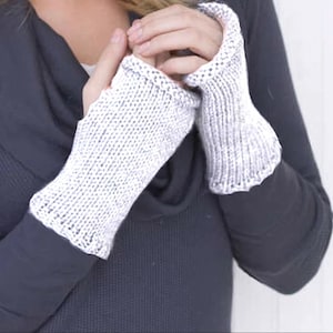 May include: A pair of white fingerless knit gloves with a textured pattern.
