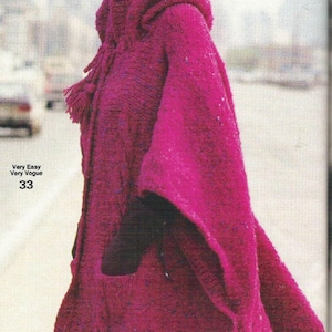 May include: A magenta knitted hooded cape with a tassel detail. The cape is made of a soft, fuzzy yarn. Very Easy Very Vogue 33.