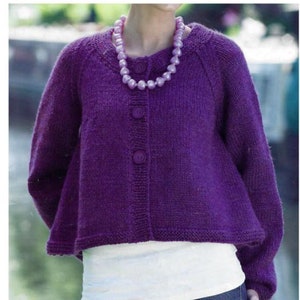 May include: A purple knitted cardigan with a button closure and a pearl necklace. The cardigan has a slightly flared hem and long sleeves.