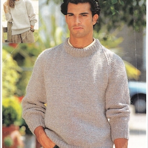 May include: A light brown knitted jumper with a round neckline and long sleeves.