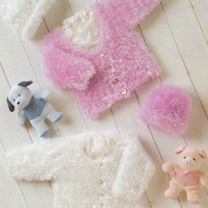 May include: Two knitted baby cardigans, one pink and one white, with matching hats. The cardigans are made with a fluffy yarn and have button closures.