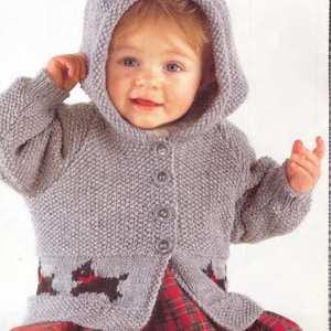 May include: A gray knitted baby cardigan with a hood and buttons. The cardigan has a black and brown dog design on the bottom.
