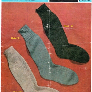 May include: Three pairs of socks in different colors: green, gray, and white. The socks are made of wool and nylon and are labeled "Talisman wool and nylon 4 ply" and "Socks for Men - Three sizes". The image also includes the text "SIRDAR 2234 1/6 (7p)".