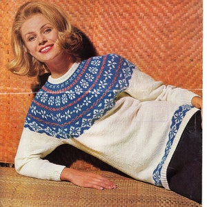 May include: A white sweater with a blue and red patterned yoke. The sweater has a crew neck and long sleeves.