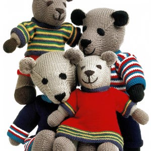 May include: Four knitted teddy bears in various colors. One bear wears a red dress, another a blue and white striped shirt, and a third a green and yellow striped shirt. The bears have brown noses and ears.