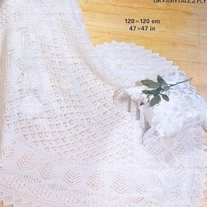May include: A white crocheted baby blanket with a delicate lace pattern. The blanket is 47 x 47 inches and is made with Patons Fairytale 3 ply yarn.