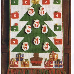 May include: A crocheted Christmas advent calendar shaped like a green Christmas tree with 24 numbered pockets. The pockets are decorated with small crocheted gifts and Santa Claus figures. The tree is sitting on a white background.
