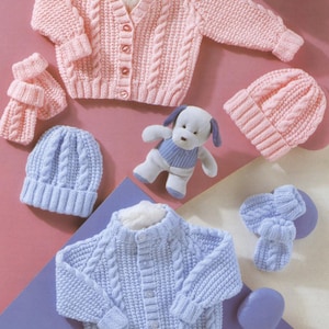 May include: Two knitted baby sets, one in pink and one in blue. Each set includes a cardigan, hat, and mittens. The cardigans have a cable knit pattern and button closures. The hats are beanie style. The mittens are fingerless.