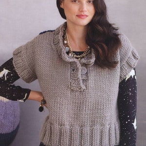 May include: A gray sleeveless knitted vest with a button closure and a cowl neck. The vest is made of a chunky yarn and has a relaxed fit.