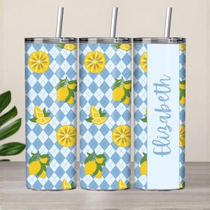May include: A stainless steel tumbler with a blue argyle pattern and yellow lemons. The tumbler has a silver lid and straw. The name "Elizabeth" is printed in a light blue script on a white vertical stripe.