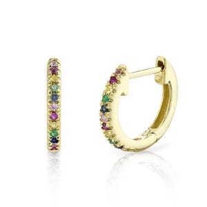 May include: A pair of gold hoop earrings with a rainbow of small gemstones set around the hoop.