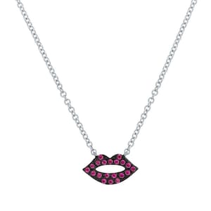 May include: A silver chain necklace with a black and pink lip pendant. The pendant is covered in small pink gemstones.
