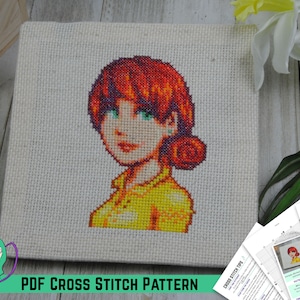 Op de afbeelding: Een kruissteekpatroon van een vrouw met rood haar en een geel shirt. Het patroon is gedrukt op wit papier en bevat instructies voor het borduren. De afgewerkte kruissteek wordt weergegeven op een canvas.