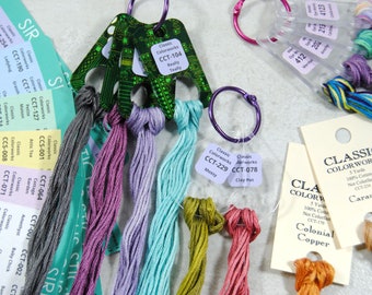 May include: A collection of embroidery floss samples organized on metal rings and paper cards. The set includes various colored threads labeled with Classic Colorworks brand names and codes like CCT-104, CCT-229, and CCT-078, alongside printed color reference strips.