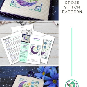 May include: Cross stitch pattern featuring a crescent moon design in shades of purple, blue, and green, with floral accents. The finished piece is displayed on a square canvas with a dark purple border. The text "SULKY MOON CROSS STITCH PATTERN" is visible.
