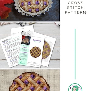 May include: Cross stitch pattern for a blueberry pie pin cushion. The pattern is printed on white paper with a grid and instructions. The finished pin cushion is shown in the top left corner of the image.