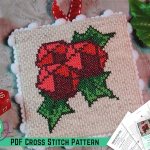 May include: A PDF cross stitch pattern for a Christmas holly ornament. The pattern features a red holly berry with green leaves. The pattern is printed on white paper with a red ribbon.