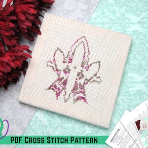 Puede incluir: Un patrón de punto de cruz con un diseño floral estilizado en tonos rosa y marrón. El patrón está impreso en papel blanco e incluye instrucciones para el punto de cruz. Las palabras "PDF CROSS STITCH PATTERN" están impresas en la parte inferior de la imagen.
