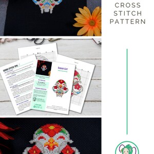 May include: Cross stitch pattern for a sugar skull cat with red, white, blue, yellow, and green embroidery floss. The pattern is called "Sugar Cat" and is available as a digital download. The pattern is on a white background with a black border.