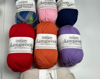 May include: Seven skeins of Cascade Yarns Longwood Sport yarn in various colors, including red, orange, purple, gray, blue, pink, and a green, blue, and gray striped skein. The yarn is 100% superwash extrafine merino wool.