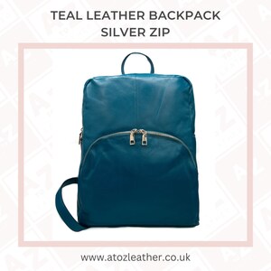 May include: Teal leather backpack with a silver zipper. The backpack has a curved front pocket and a top handle. The text "TEAL LEATHER BACKPACK SILVER ZIP" is at the top of the image. The website address www.atozleather.co.uk is at the bottom.