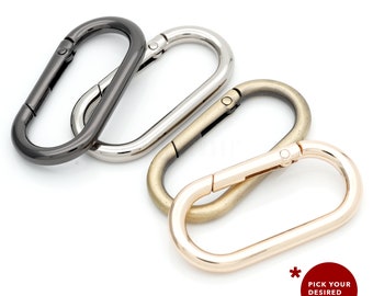 May include: Four oval-shaped metal clasps in different finishes: black, silver, antique gold, and rose gold.  Pick your desired color!