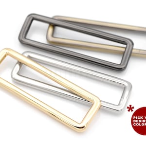 May include: Four metal rectangular rings in gold, silver, and black finishes.  Pick your desired colour!