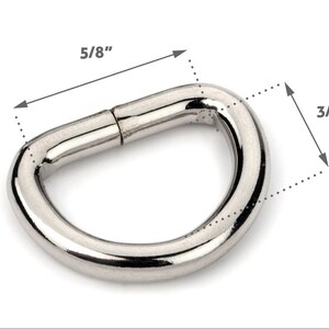 May include: A silver metal D-ring with a 5/8 inch diameter and a 3/8 inch width.