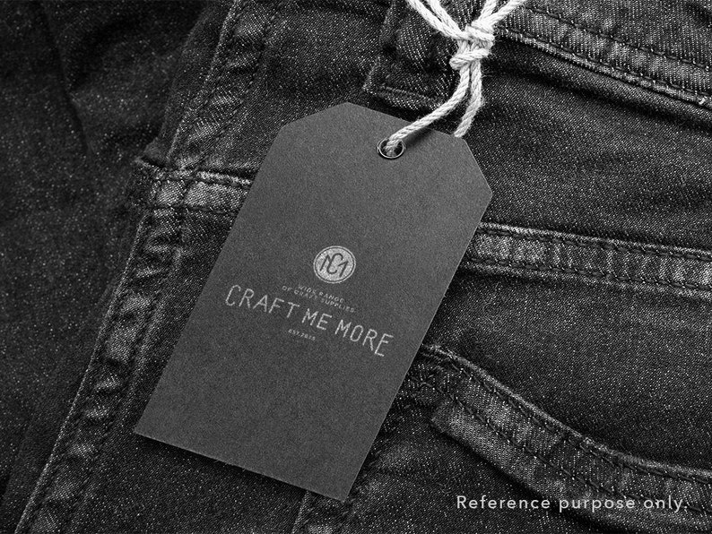 May include: Black and white tag with the text "Craft Me More" and a logo that says "NC1 Wide Range Of Craft Supplies Est. 2013" attached to a pair of black denim jeans.