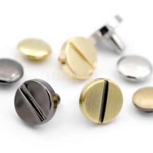 May include: Assortment of metal screw-back buttons in various finishes, including gold, silver, black, and brass.