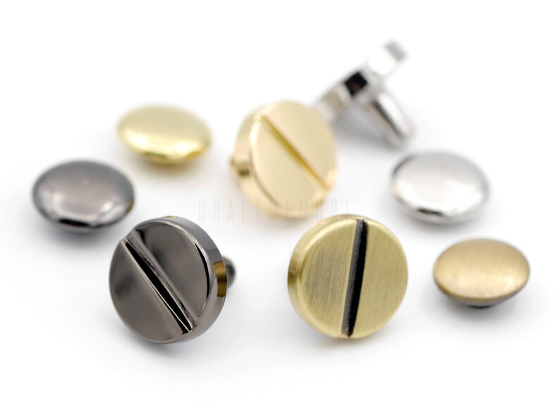 May include: Assortment of metal screw-back buttons in various finishes, including gold, silver, black, and brass.