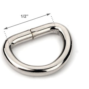 May include: A silver metal D-ring with a 1/2 inch diameter.
