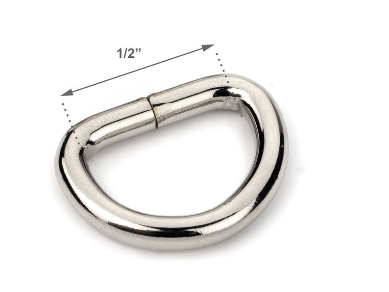 May include: A silver metal D-ring with a 1/2 inch diameter.
