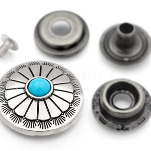 May include: A set of silver-toned metal snap fasteners with a turquoise stone in the center of the top button. The set includes a top button, a bottom button, a cap, and a stud.