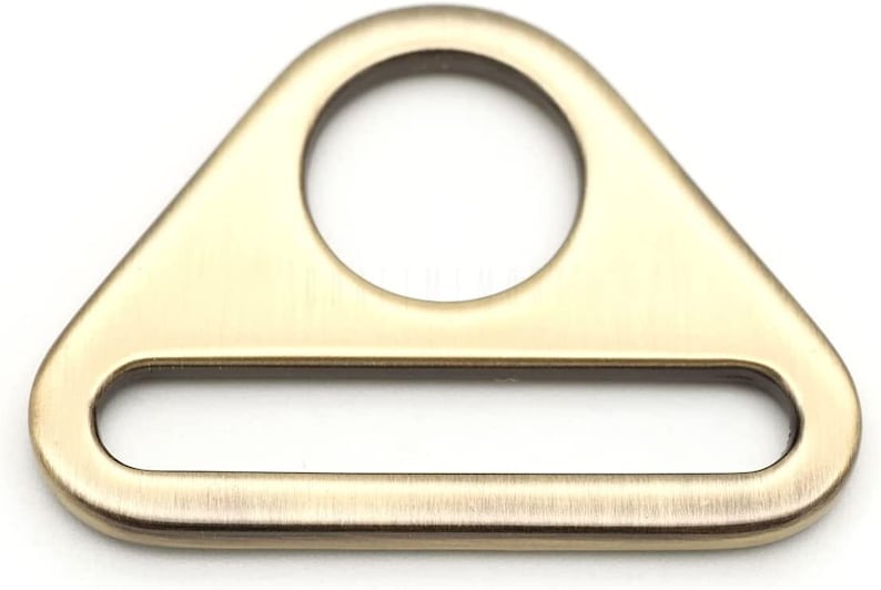 May include: A gold-toned metal triangle-shaped buckle with a round hole and a rectangular slot.