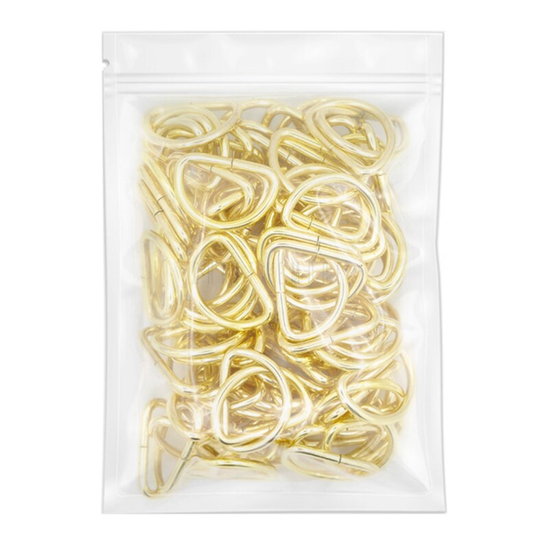 May include: A clear plastic bag filled with gold-colored metal D-rings. The D-rings are approximately 1 inch in diameter.