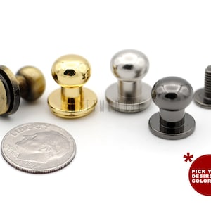 May include: Four metal push buttons in gold, silver, and black. The buttons are round with a flat base and a raised dome. The buttons are about the size of a US dime.