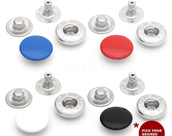 May include: Assortment of snap buttons in various colours, including black, white, red, and blue. The buttons are made of metal and have a shiny finish. Each button has a raised centre and a decorative rim. The buttons are arranged in a grid pattern on a white background. Pick your desired colour!