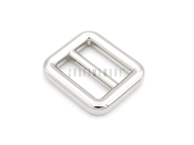 May include: Silver metal buckle with a rectangular shape and a smooth finish.