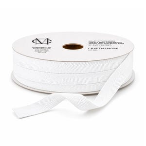 May include: A spool of white herringbone ribbon with a portion unrolled. The spool has text that reads "Handcrafted Possibilities Unlimited Creativity" and "Craftmemore". The ribbon is a bright white color.