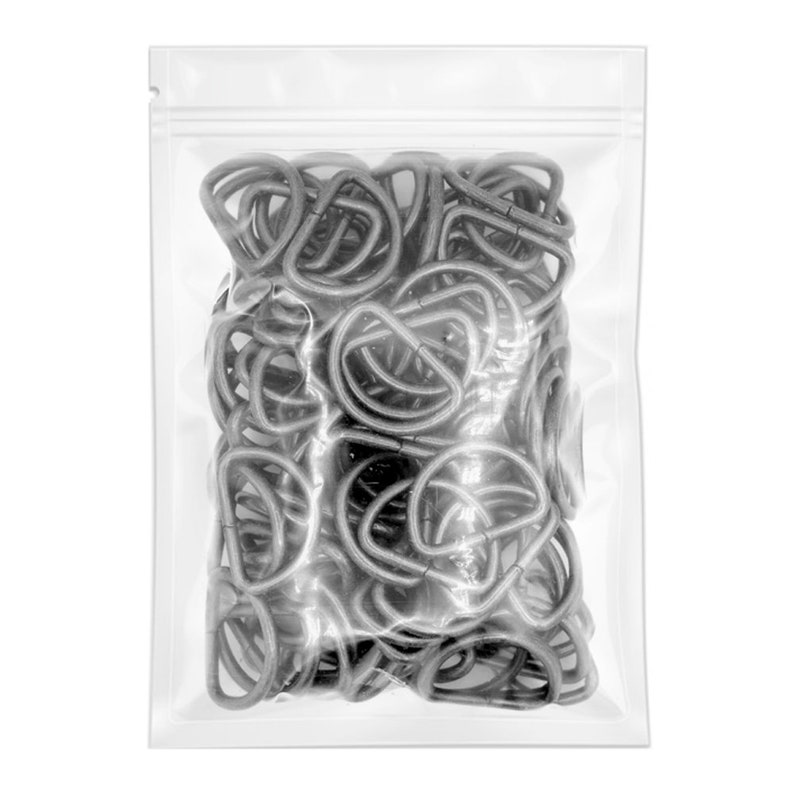 May include: A clear plastic bag filled with silver metal D-rings. The D-rings are all the same size and are arranged in a random pattern.