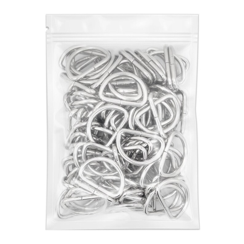 May include: A clear plastic bag filled with silver metal D-rings. The D-rings are all the same size and are arranged in a random pattern.