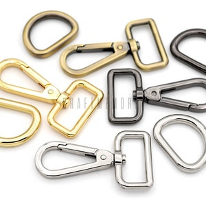 Könnte beinhalten: Sortiment aus Metall-Schwenkverschlüssen und D-Ringen in Gold-, Silber- und Schwarz-Finish. Diese Beschläge eignen sich hervorragend zum Basteln von Taschen, Handtaschen und anderen Accessoires.