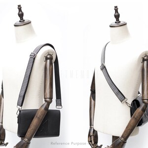 May include: A black leather crossbody bag with a black and white chevron patterned strap. The bag is shown on a white mannequin.