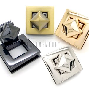 May include: Four square-shaped metal clasps with a pyramid-shaped stud in the centre. The clasps are in four different finishes: gold, silver, black, and antique brass.