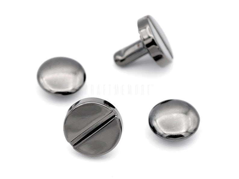 May include: Four black metal rivets with a flat round head and a post. The rivets have a shiny finish.